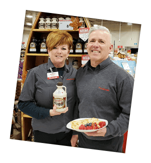 Steve & Joanne Strom of Elliot Lake hold their favourite holiday products in front of a stand in their Foodland store.