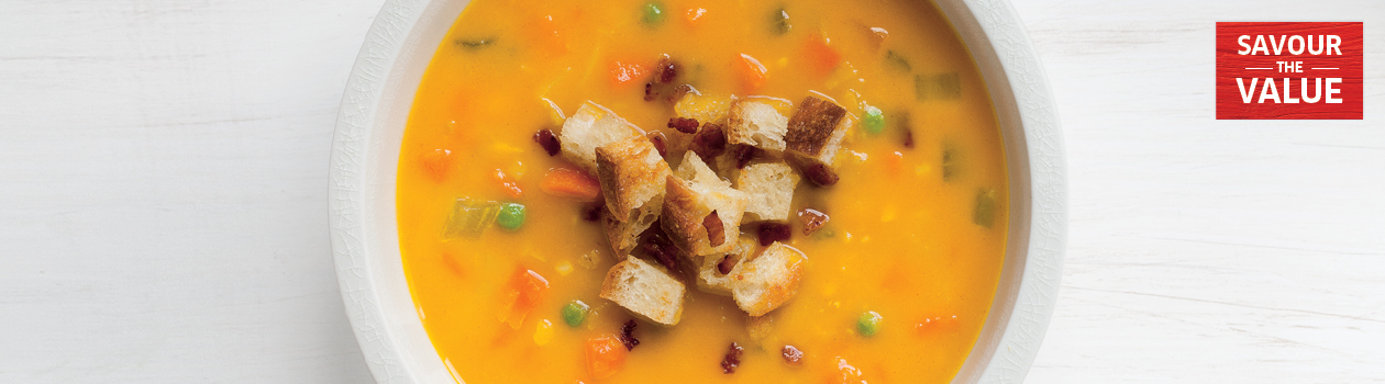Creamy vegetable soup with bacon croutons